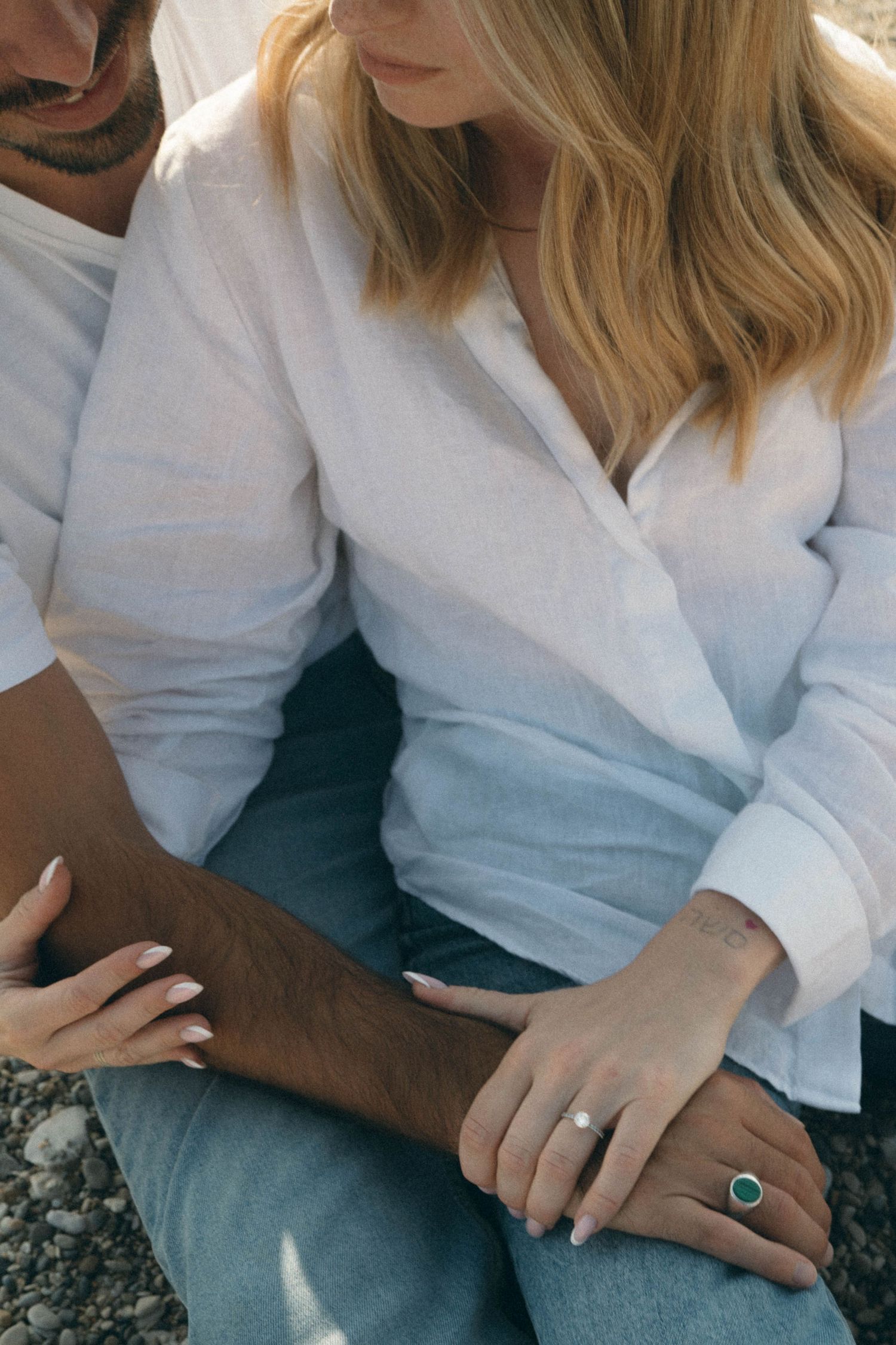 Close-up photo series showing hands with engagement ring in white shirt against dark background.
