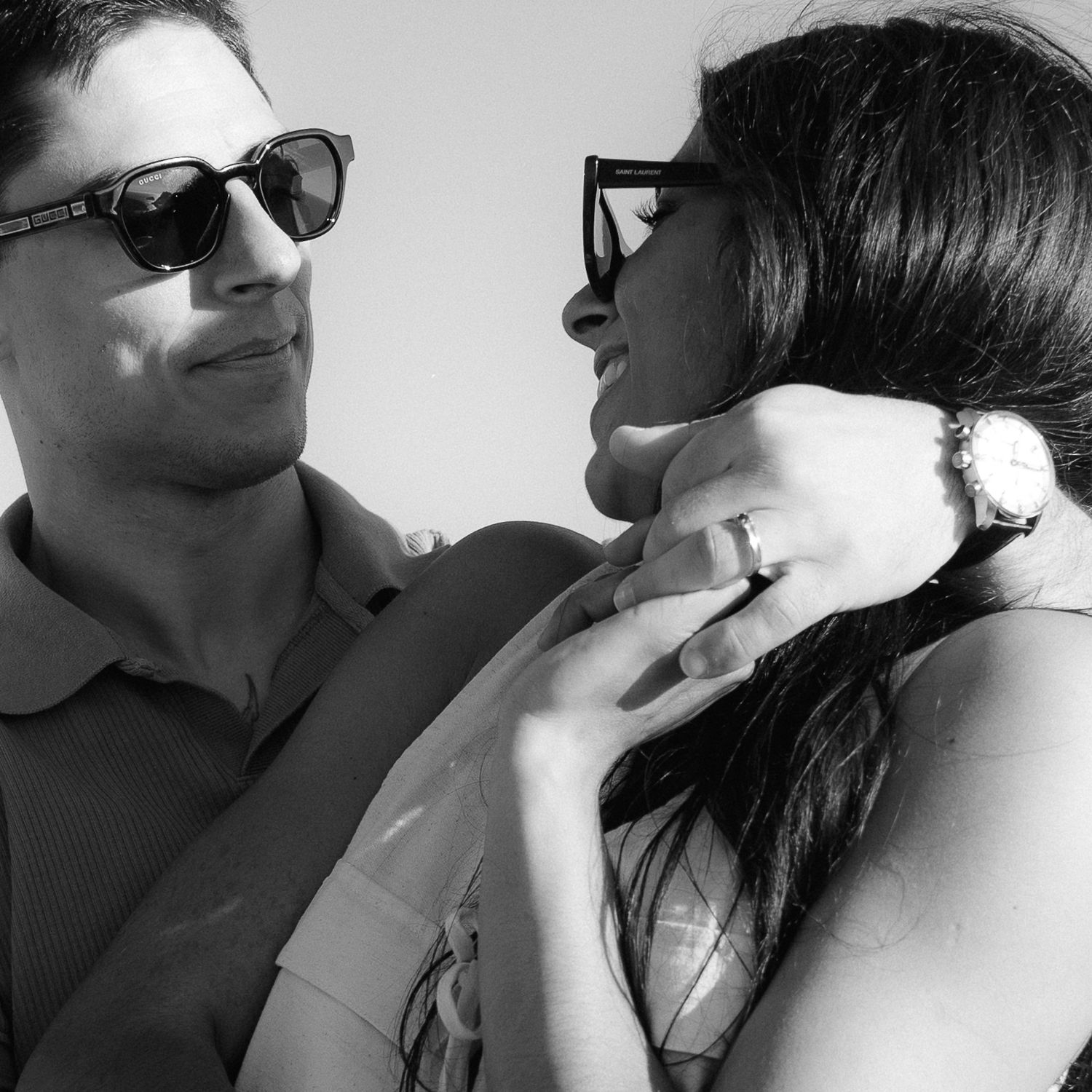 A series of black and white photographs showing close-up moments of intimacy between two people wearing sunglasses.