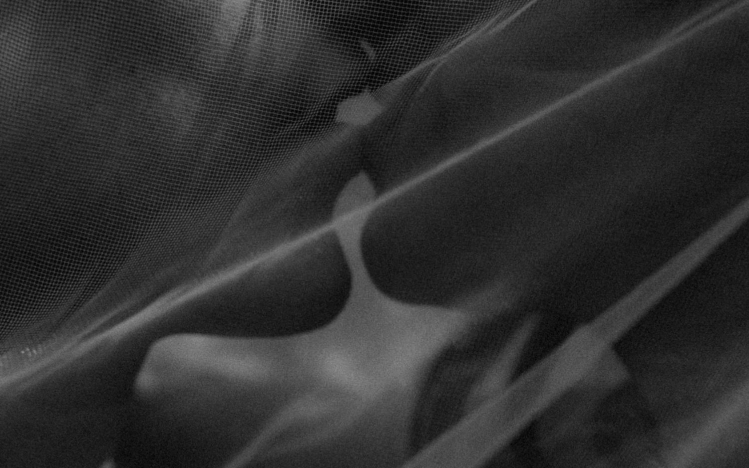 Abstract black and white photograph showing diagonal lines and curves creating a moody artistic composition.