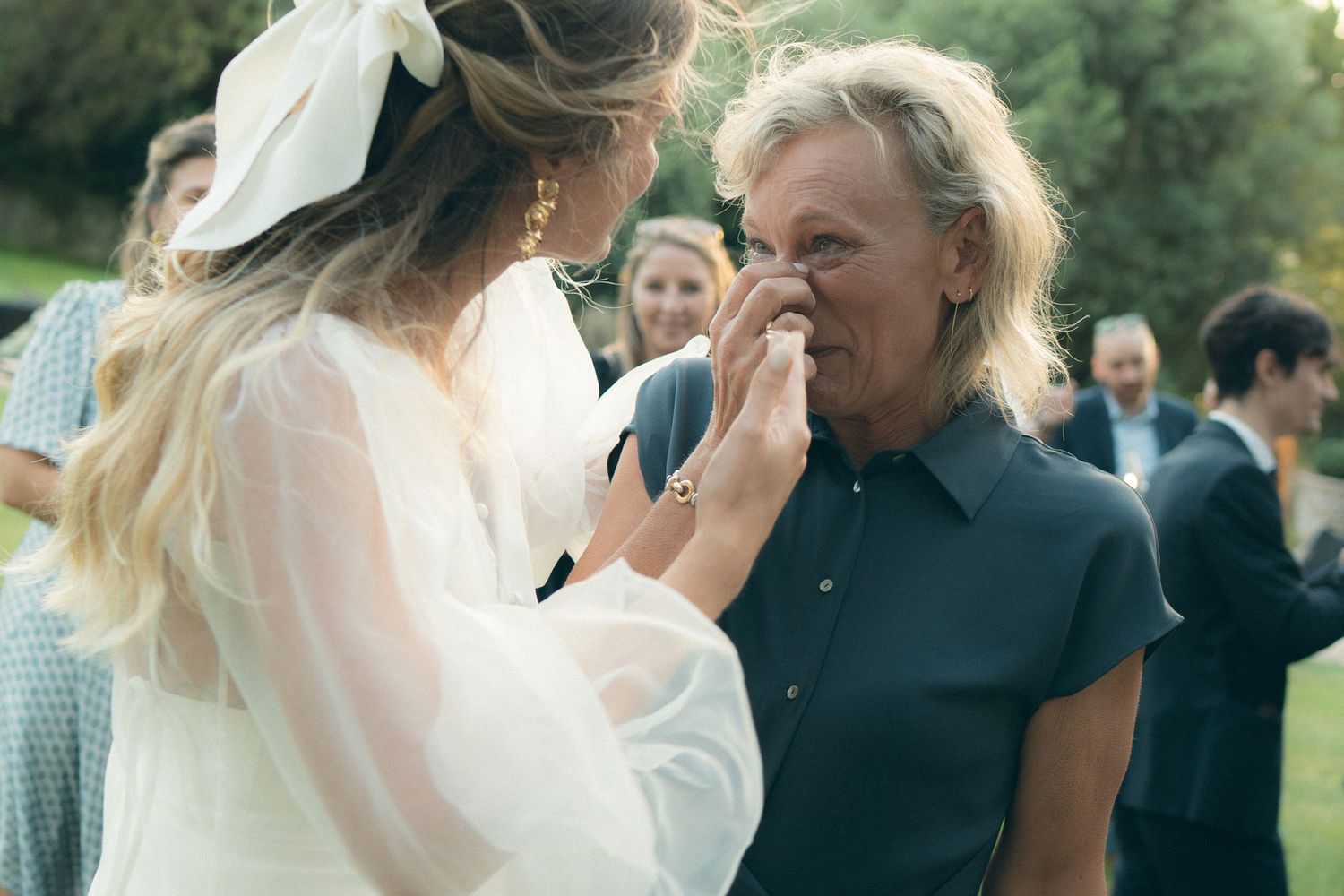 A joyful wedding celebration with guests dancing and mingling outdoors during a summer garden party.