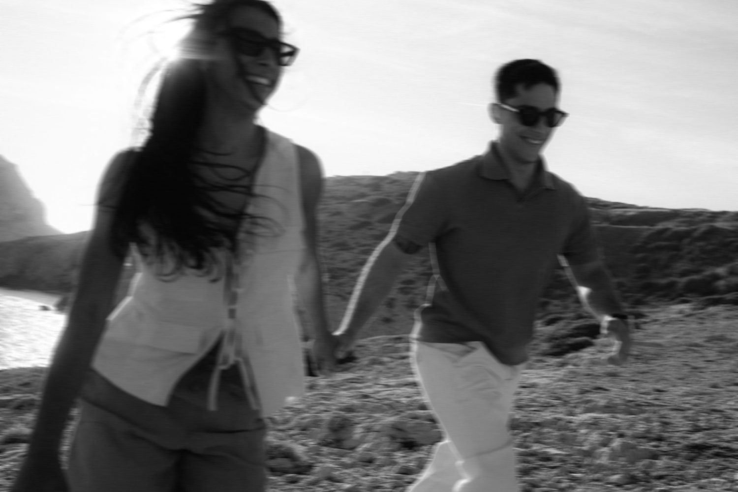 Black and white photo series showing people walking and hiking along a rugged mountain trail at sunset.