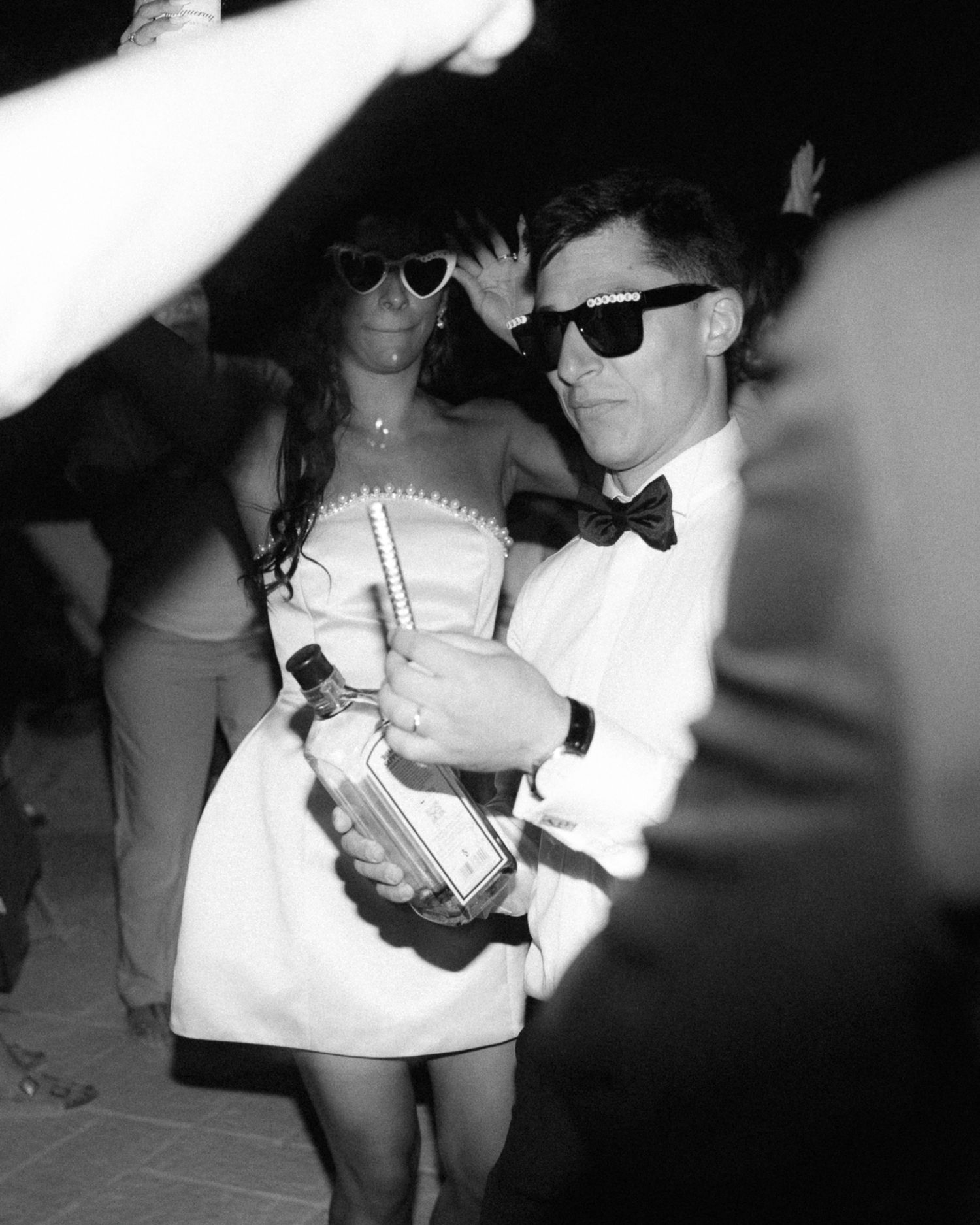 Black and white photo series showing people in sunglasses and bow ties at a party or event.