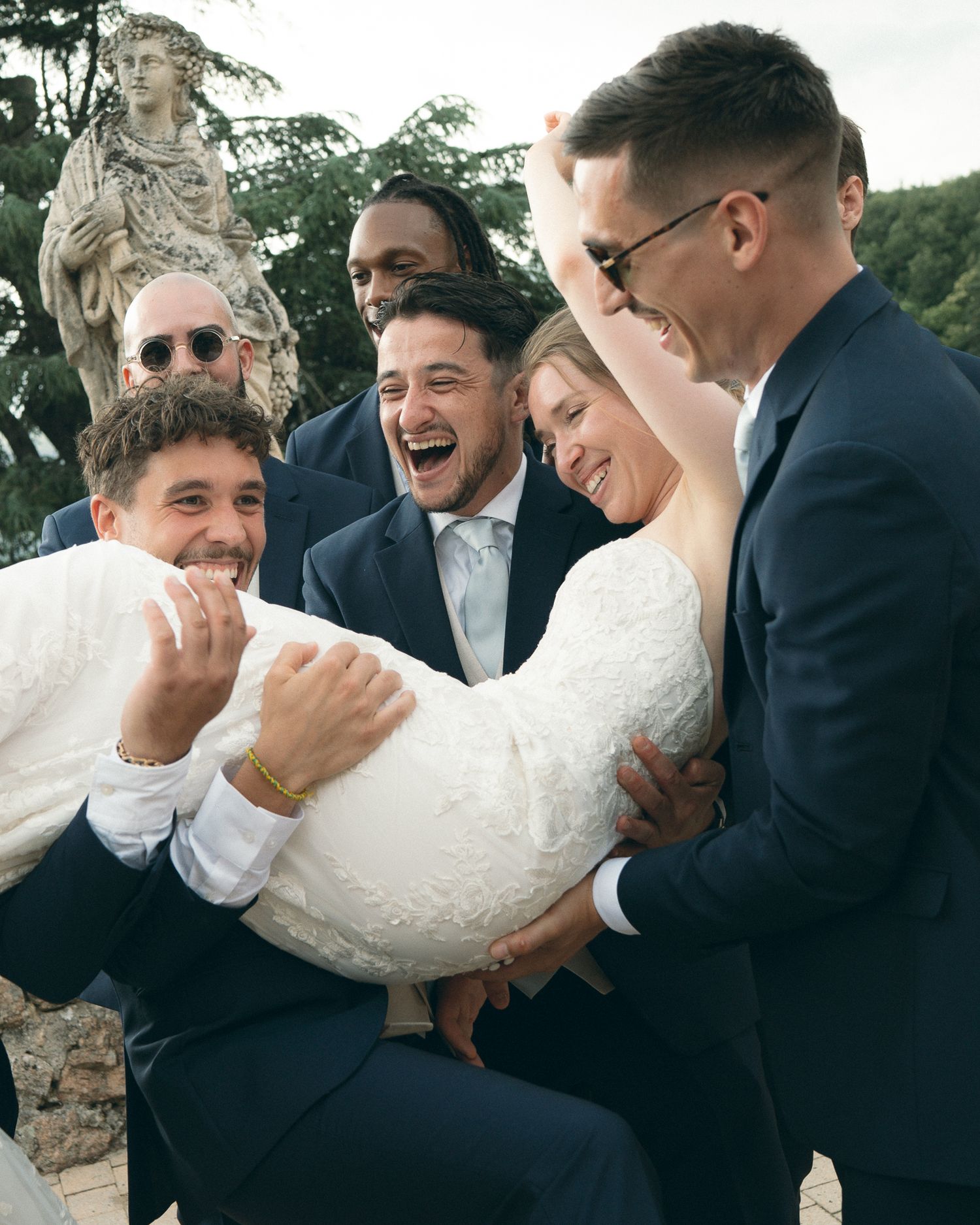 A sequence of wedding photos showing groomsmen laughing and sharing a playful moment during outdoor formal portraits.
