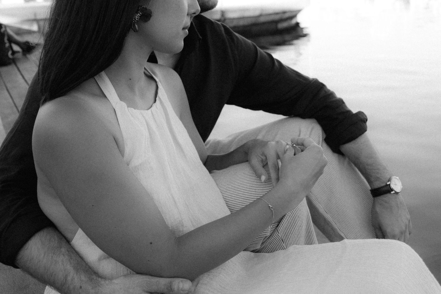 Black and white photo series showing hands holding and writing on paper in various positions.