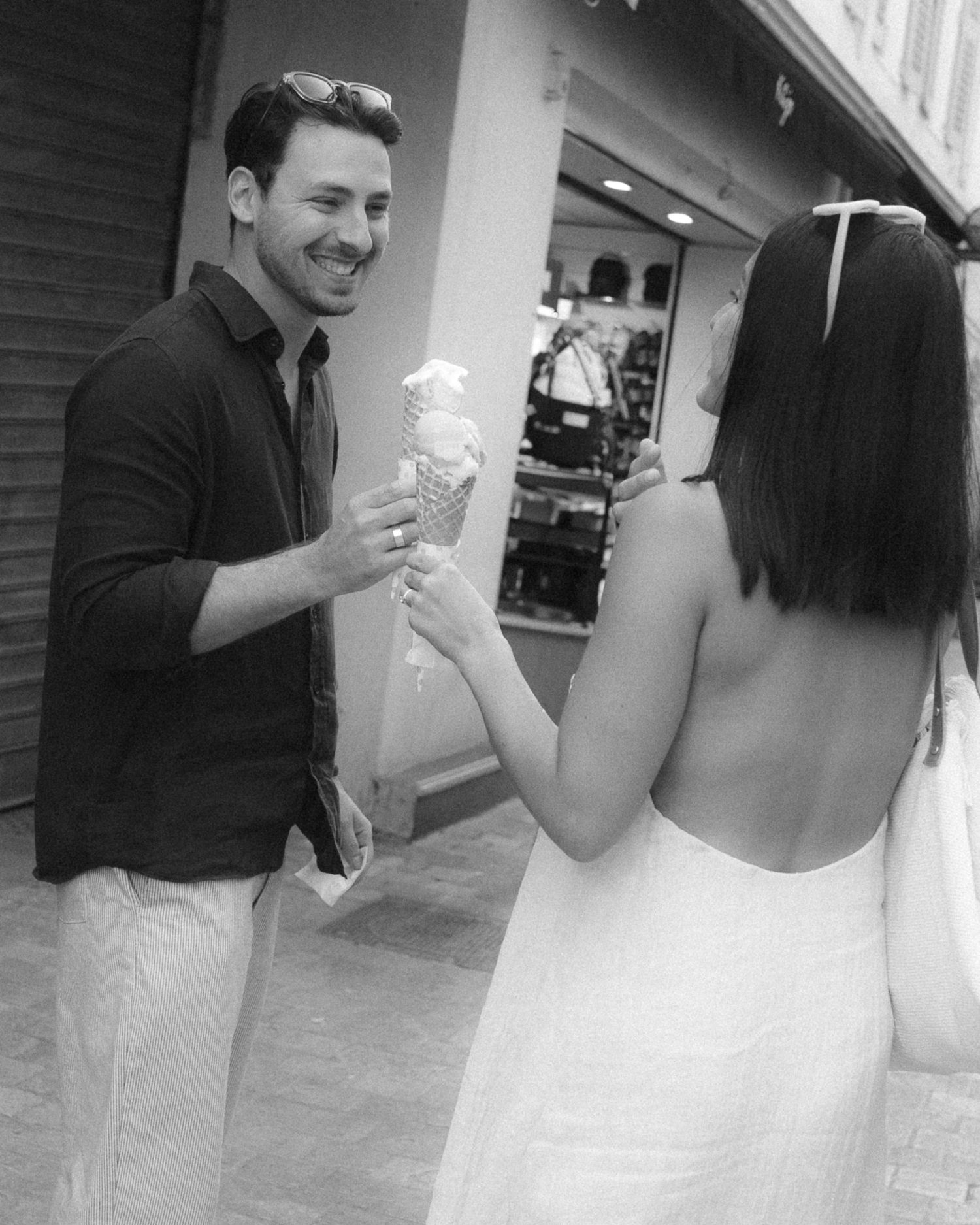 A sequence of black and white photos showing a couple dancing together in a playful, candid moment.