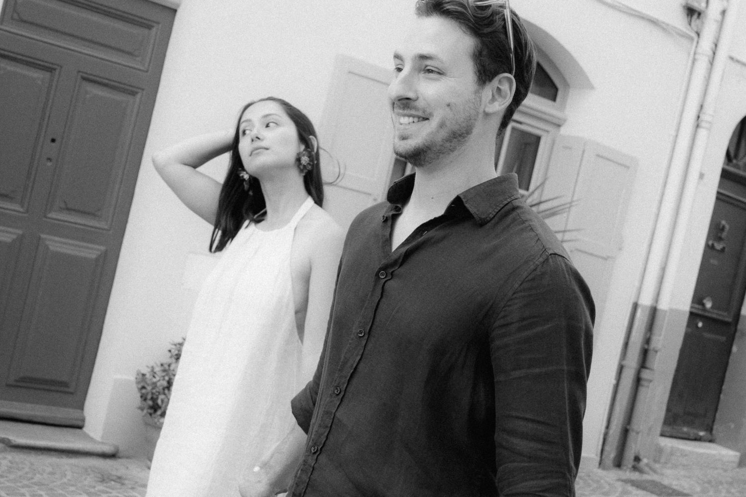 A black and white photo collage showing romantic moments between a couple in formal attire.