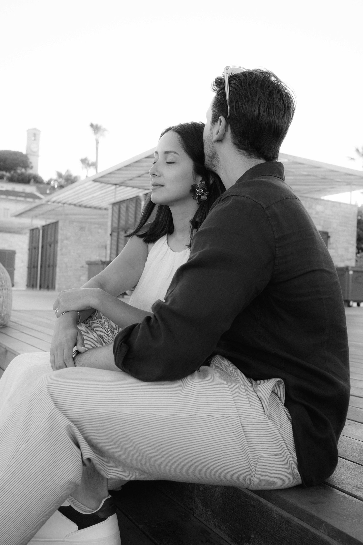 A black and white series of romantic couple photos showing intimate moments on a porch.