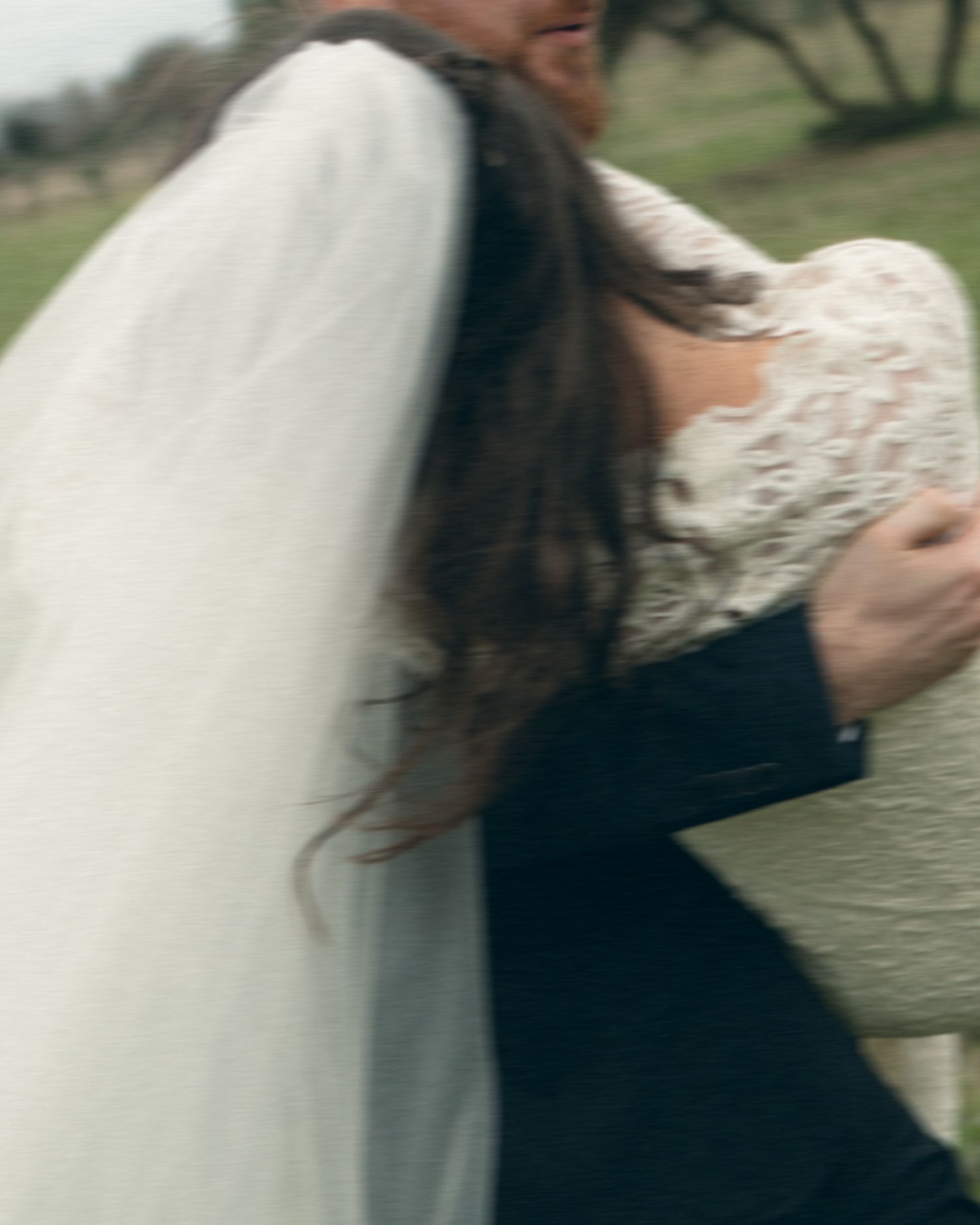 A blurred motion sequence shows two people in white and black attire dancing together outdoors.