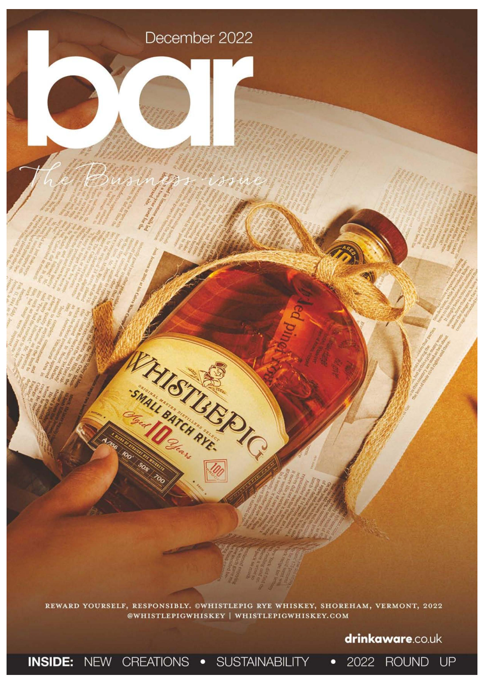 Bar magazine cover featuring artistically lit whiskey bottle on dictionary pages.
