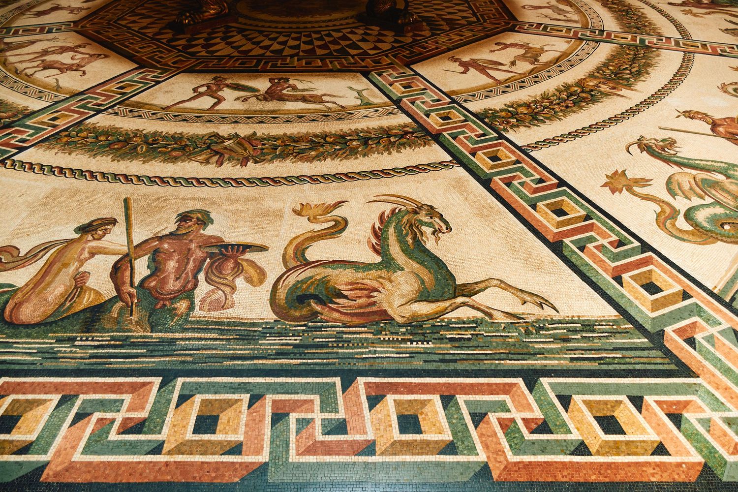 Ancient Roman mosaic floor depicting mythological creatures and geometric patterns in vibrant colors.