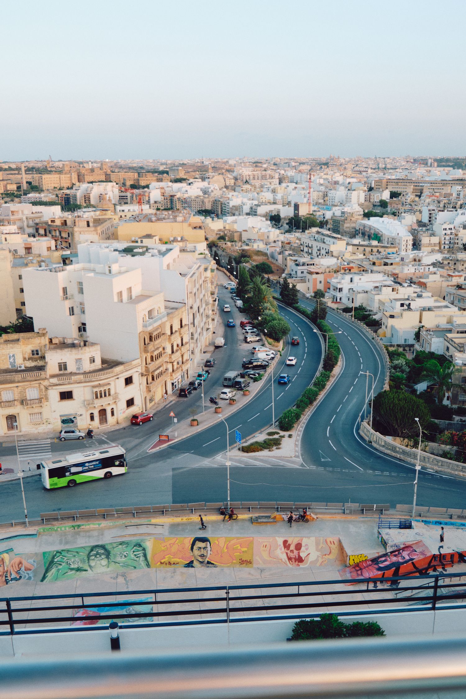 Aerial view of curved city streets and architecture in Malta with urban buildings.