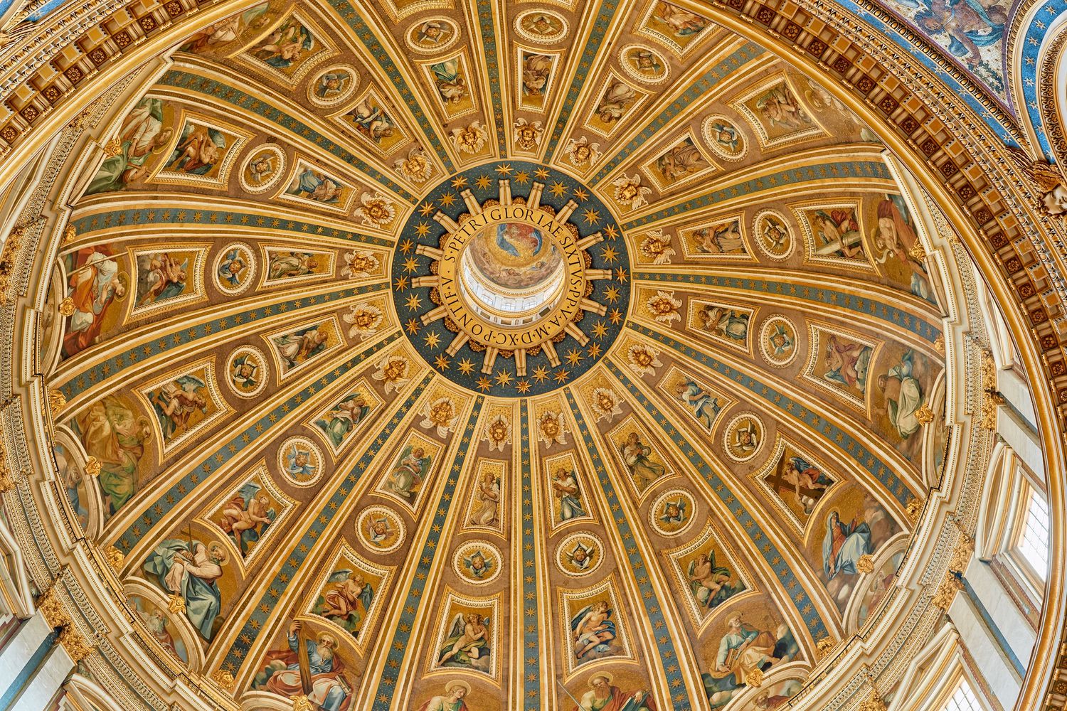 Ornate dome with golden decorations and religious artwork radiating from central oculus in Saint Peter's Basilica.