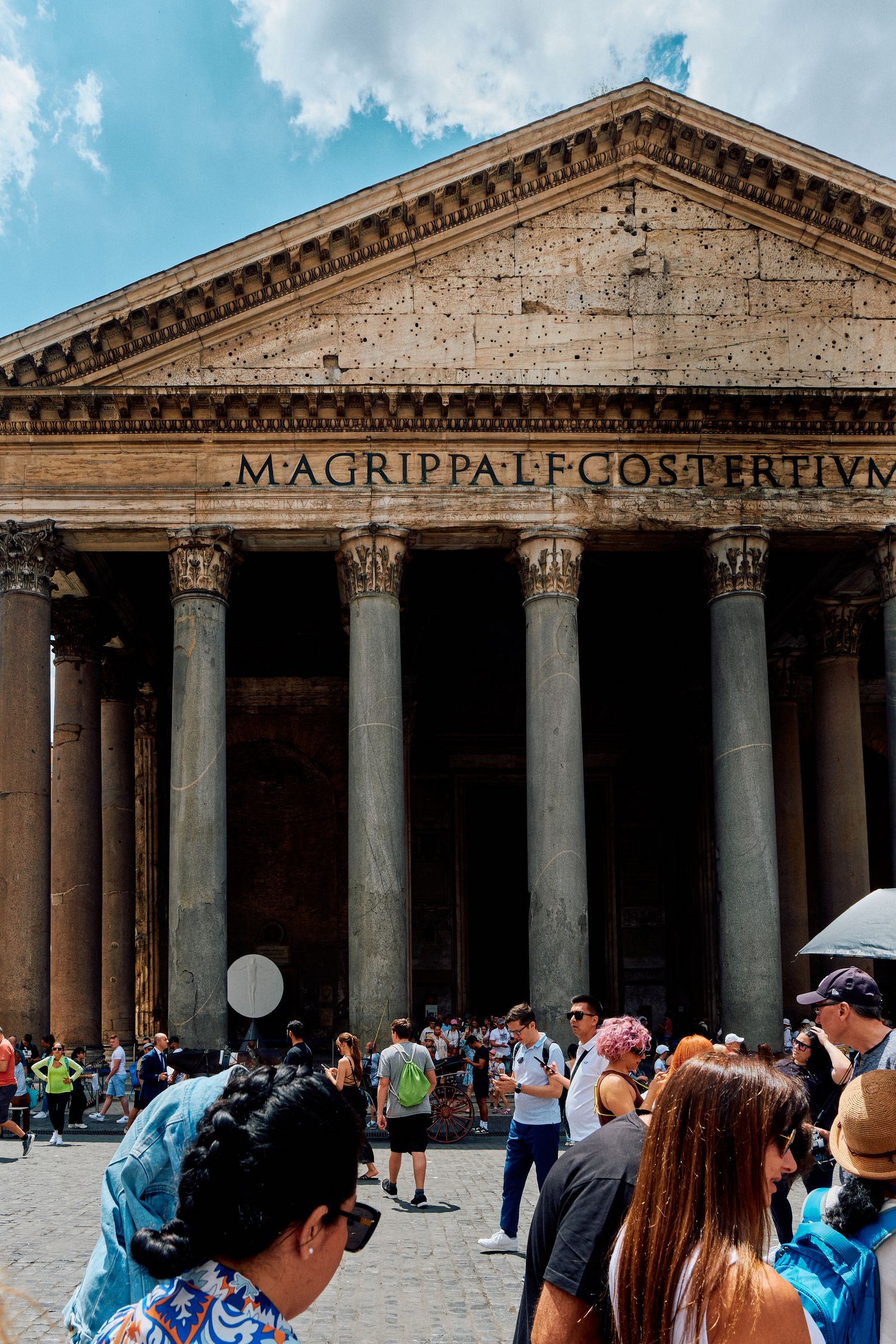Front view of the Pantheon in Rome with its famous classical columns and pediment inscription.
