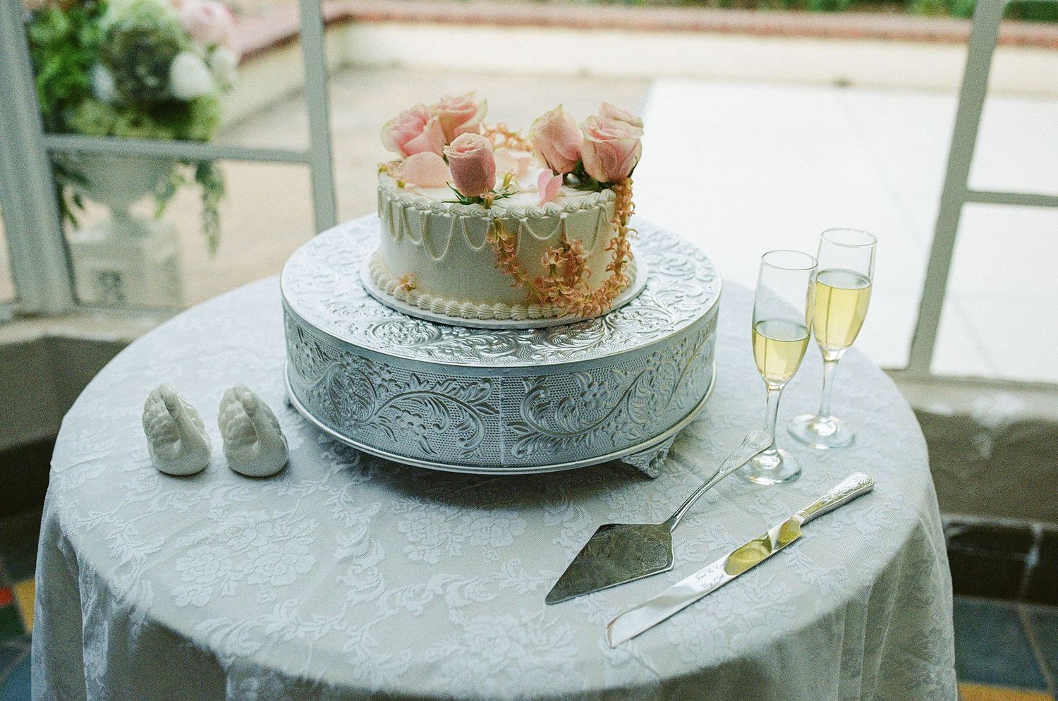 Film photography of a wedding cake and wedding cake topper at a Los Angeles wedding venue Orcutt Ranch.
