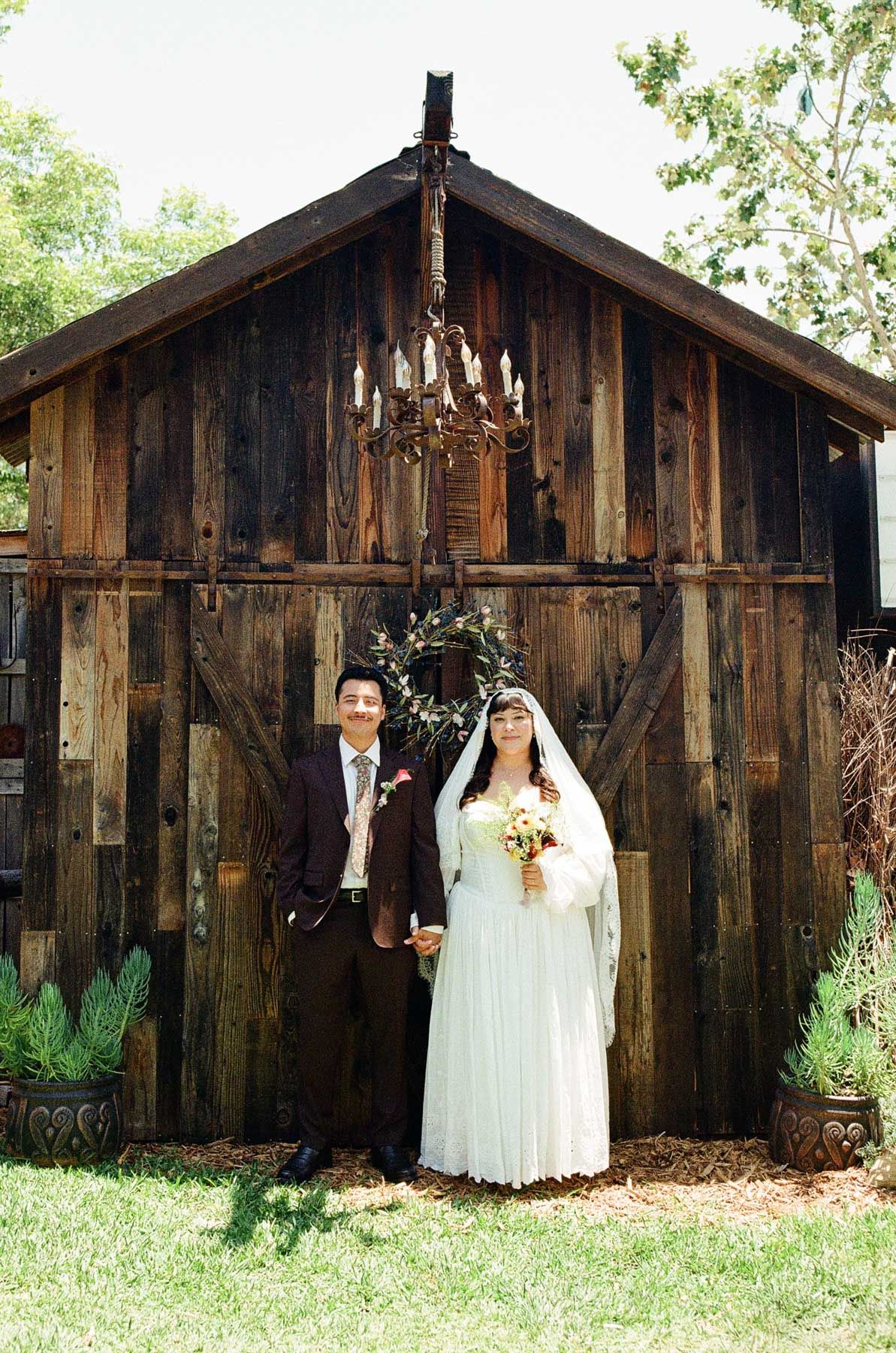 Los Angeles wedding couple with old brown barn in funky Los Angeles wedding shot on film photography