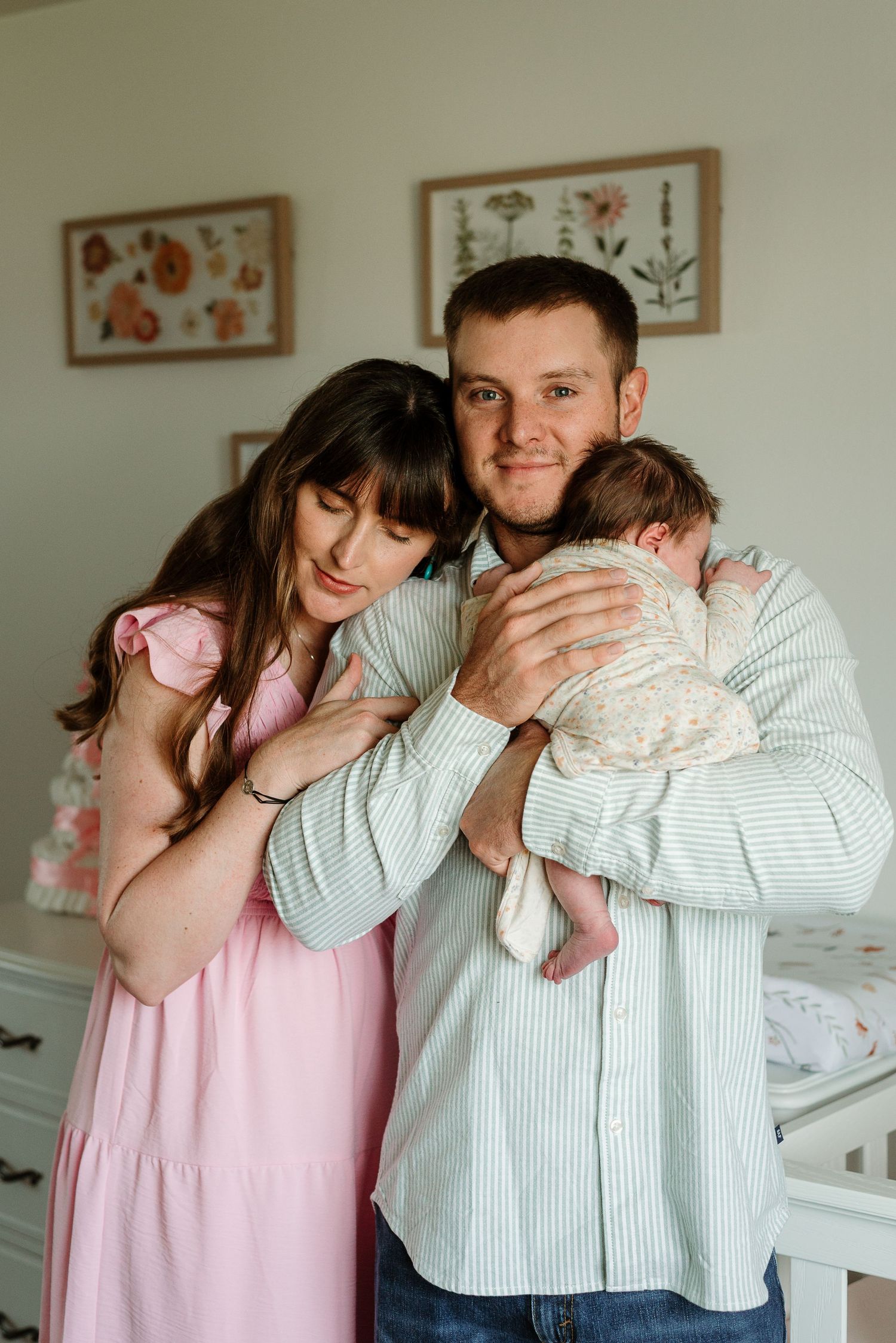 A series of photos showing tender family moments in a nursery with pink and white decor.