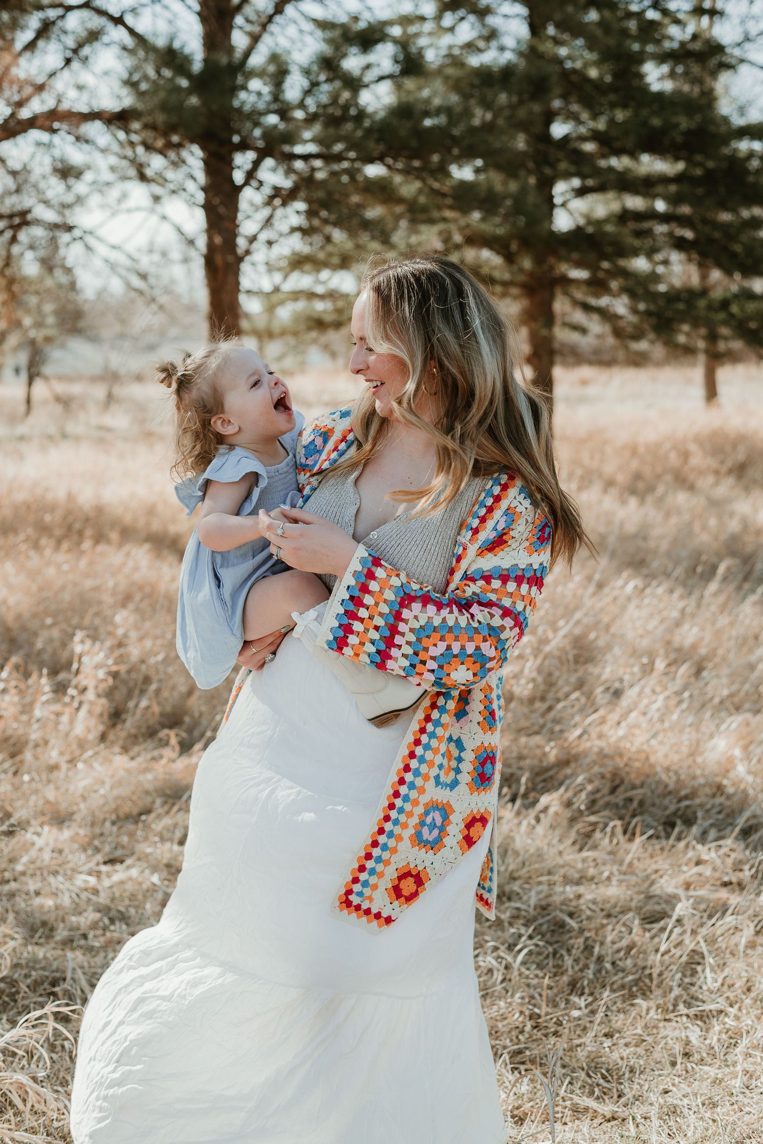 Joyful outdoor moments shared between two people in coordinating outfits among tall grass.