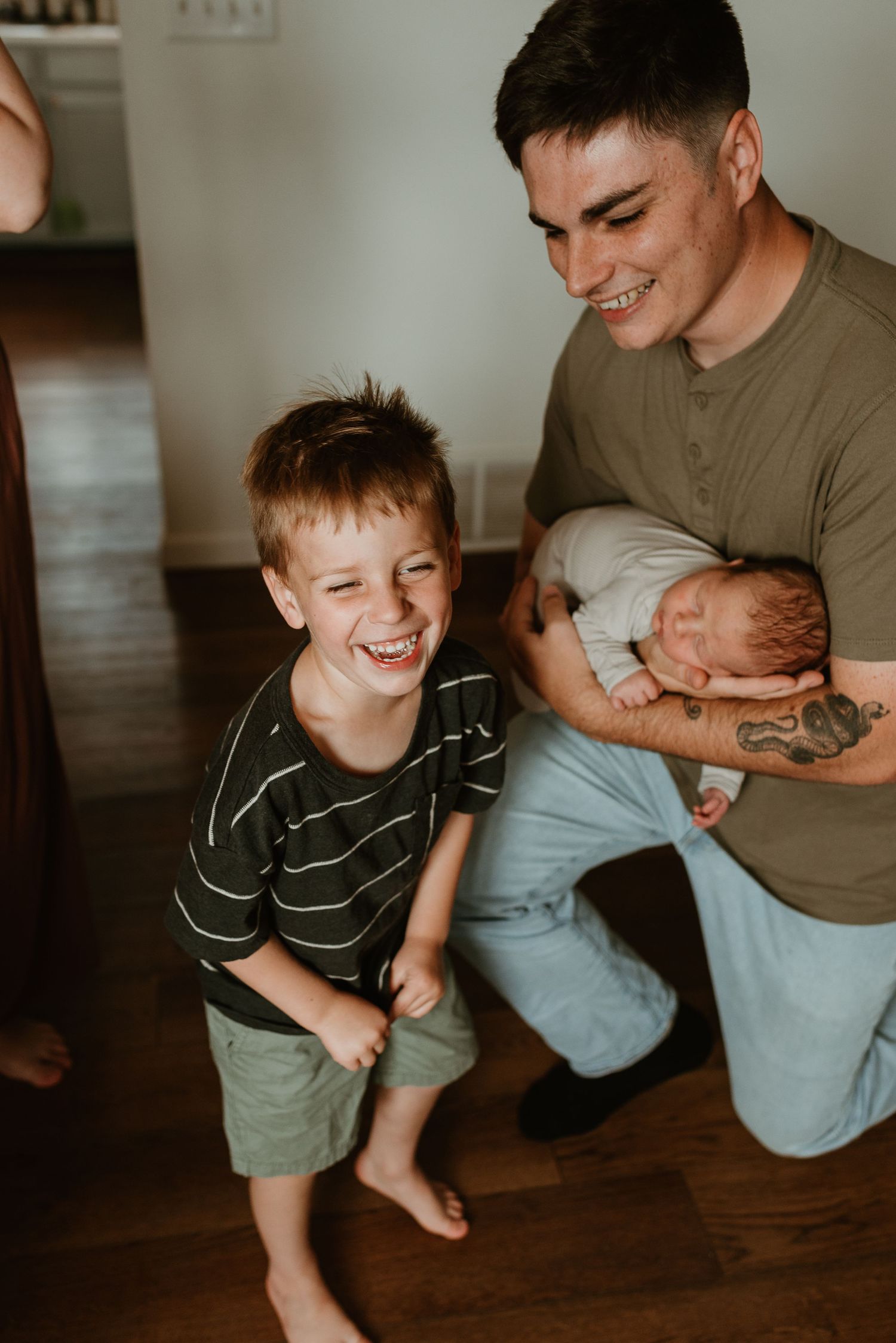 Joyful indoor family scene with candid laughter and interaction in warm lighting.