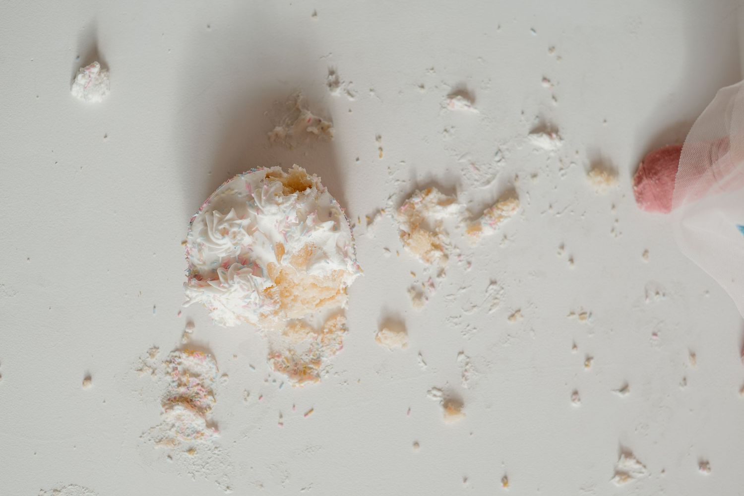 Close-up photos showing powdered sugar and crumbs scattered across a light surface in a sequence.