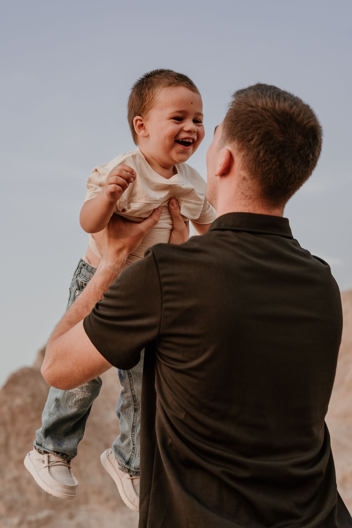 Playful sequence showing happy interactions between parent and child against desert backdrop.