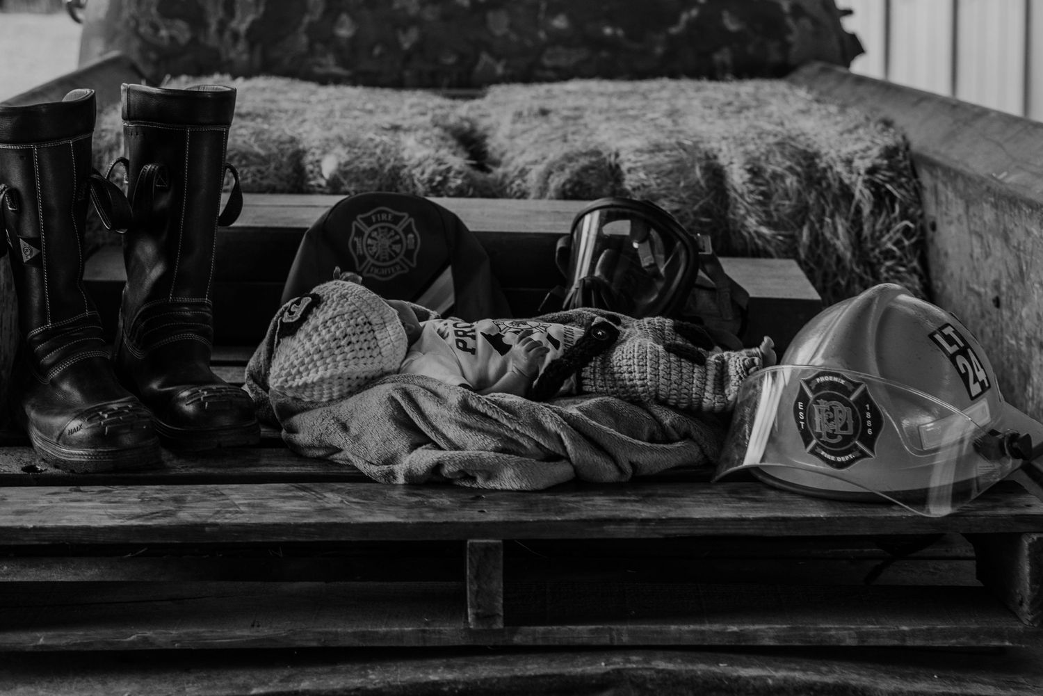 Black and white image of people resting on blankets.