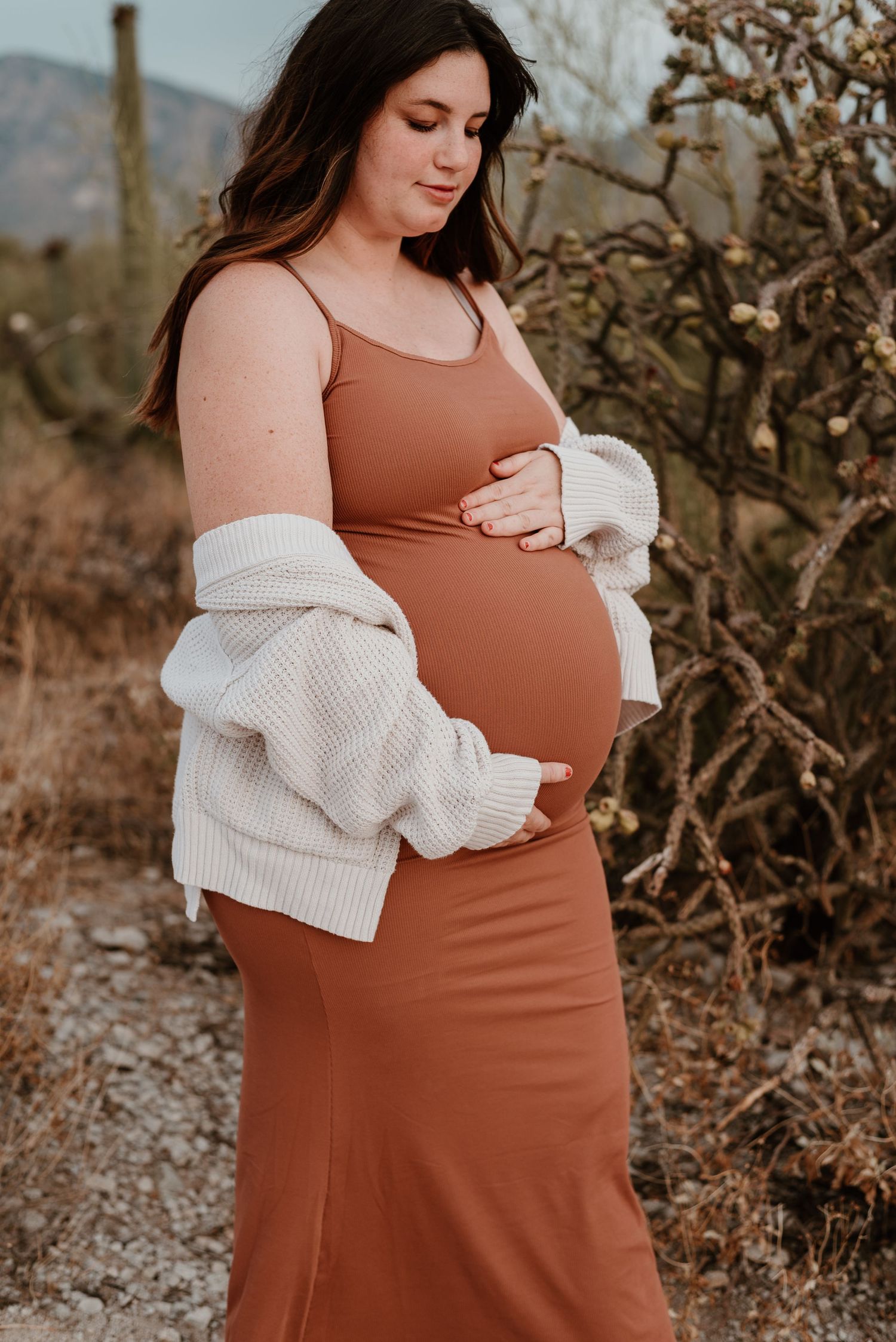 Pregnant woman embraces belly