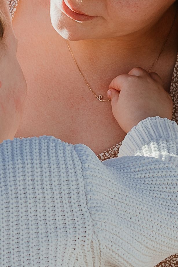 Son plays with mom's necklace