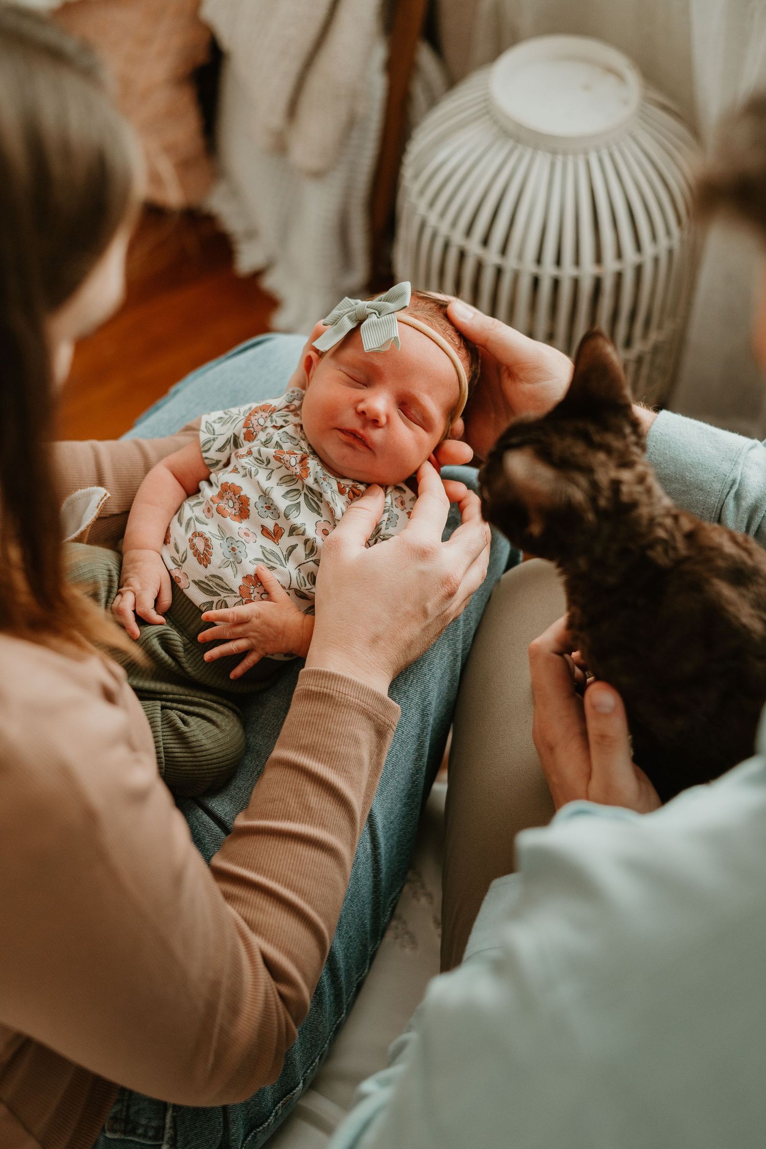 A tender moment between a baby in a floral outfit and caregiver shown in a series of intimate photos.