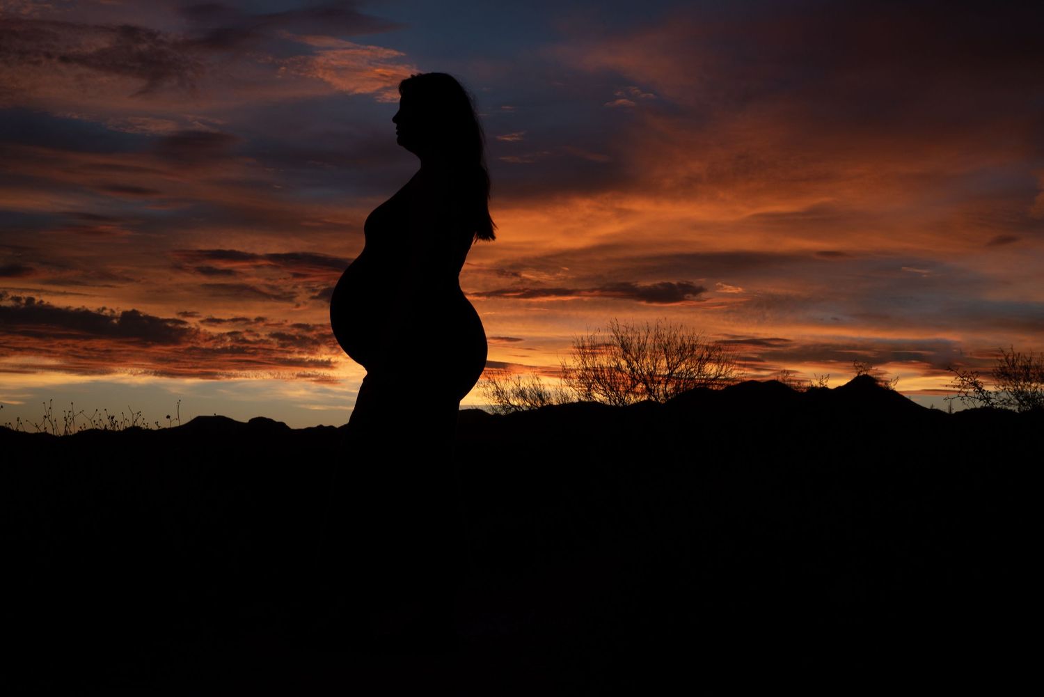 Pregnant woman sunset silhouette