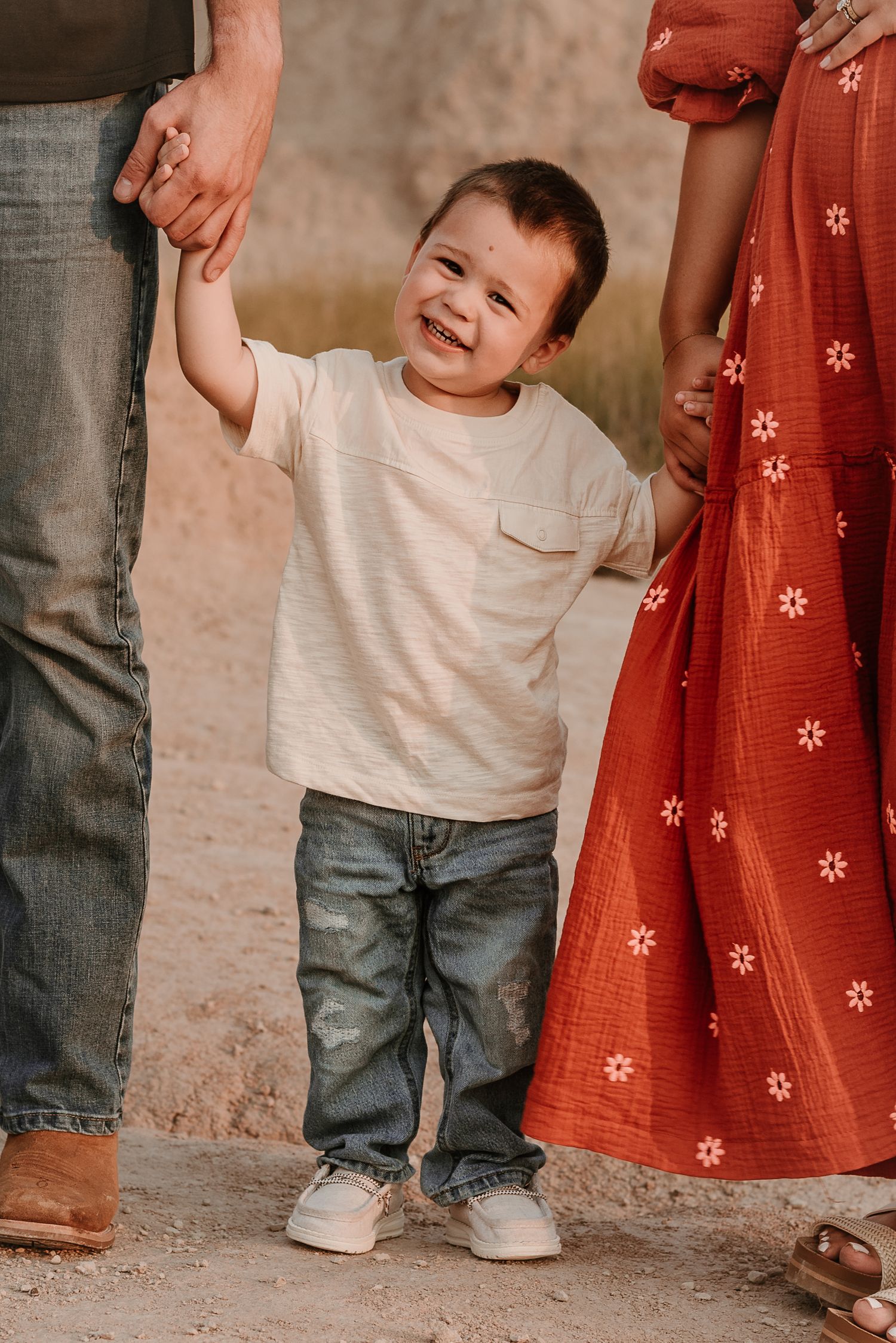 Close-up shots of a toddler in jeans and white shirt playing outdoors.