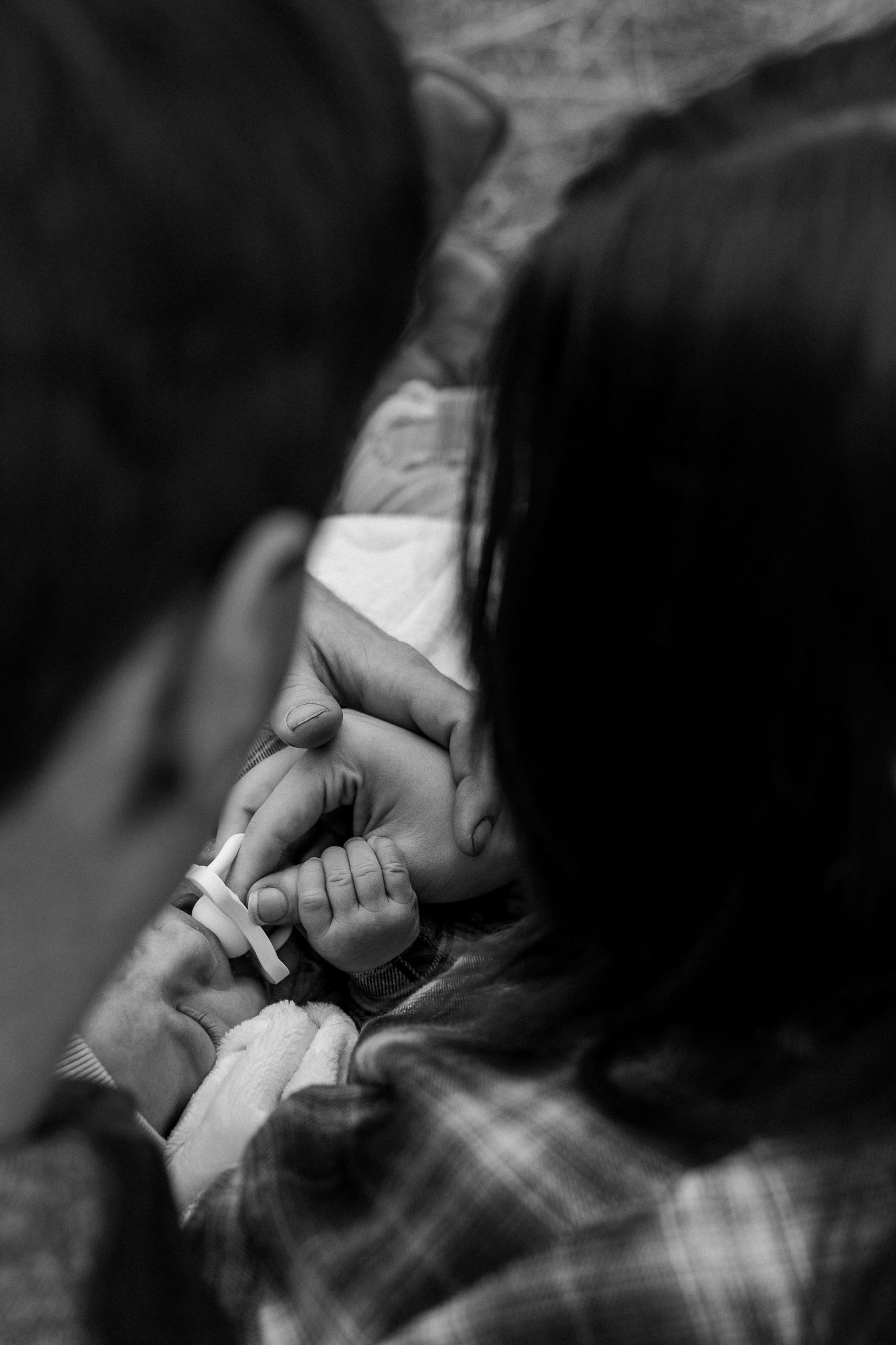 A series of black and white close-up shots showing hands rolling a cigarette with tobacco and paper.