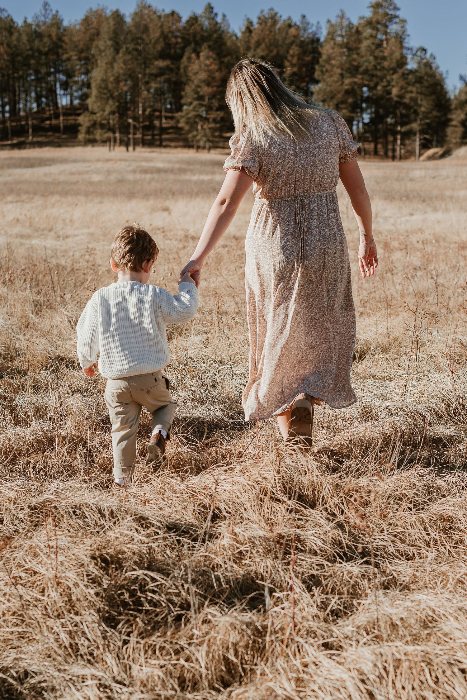 Mom and son walk holding hands