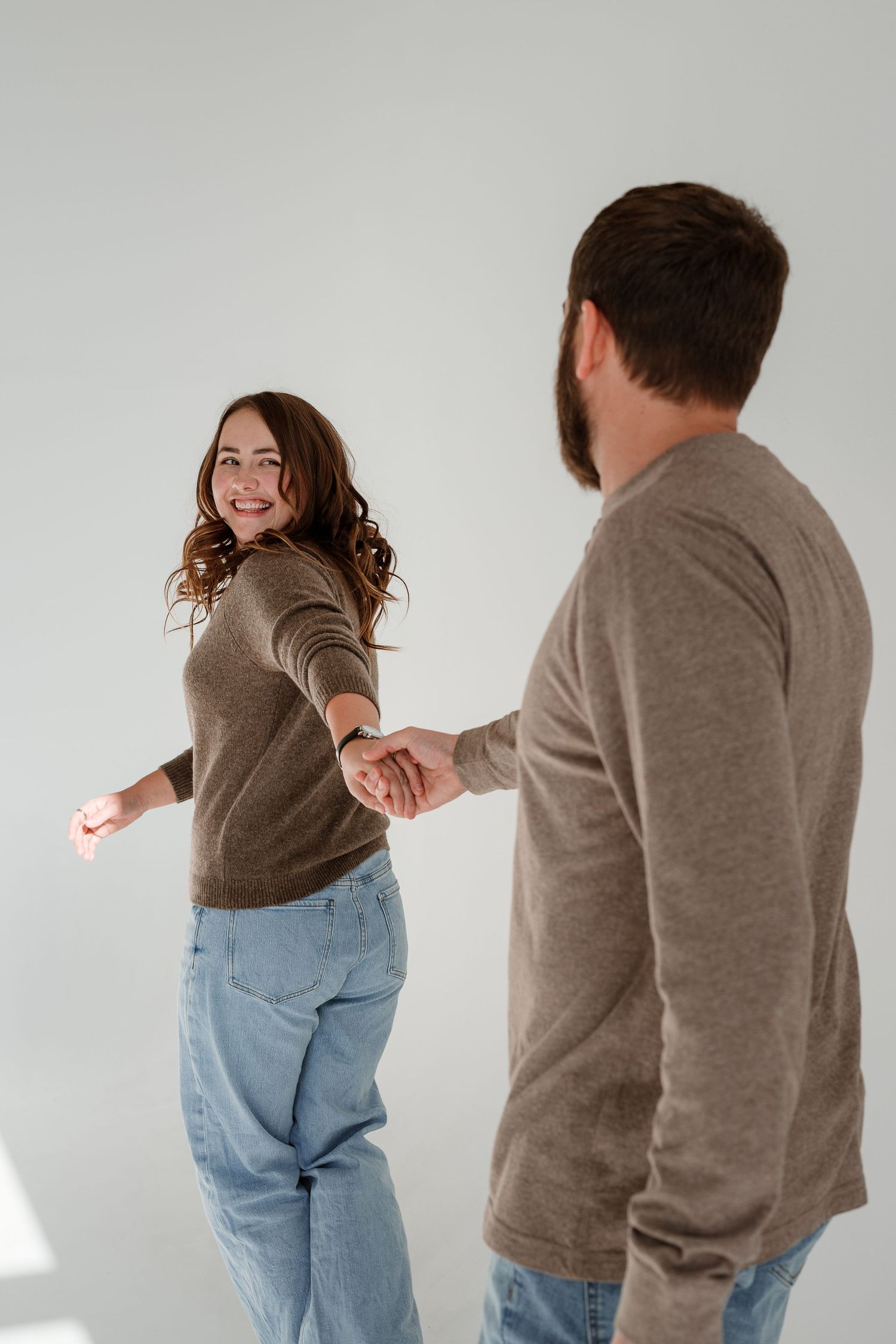 Two people in casual clothing demonstrate dance moves in a sequence against a white background.