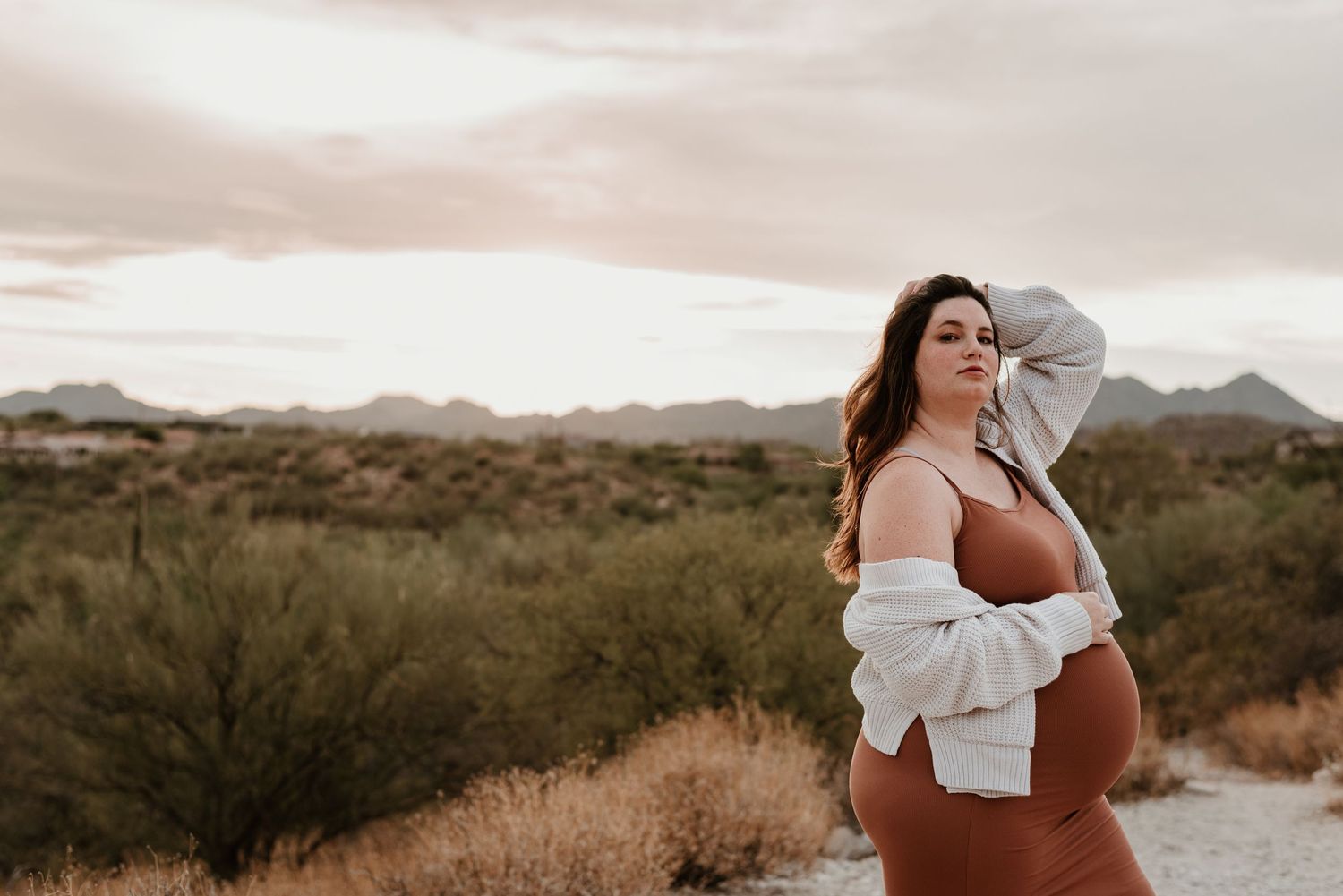 Pregnant woman plays with hair