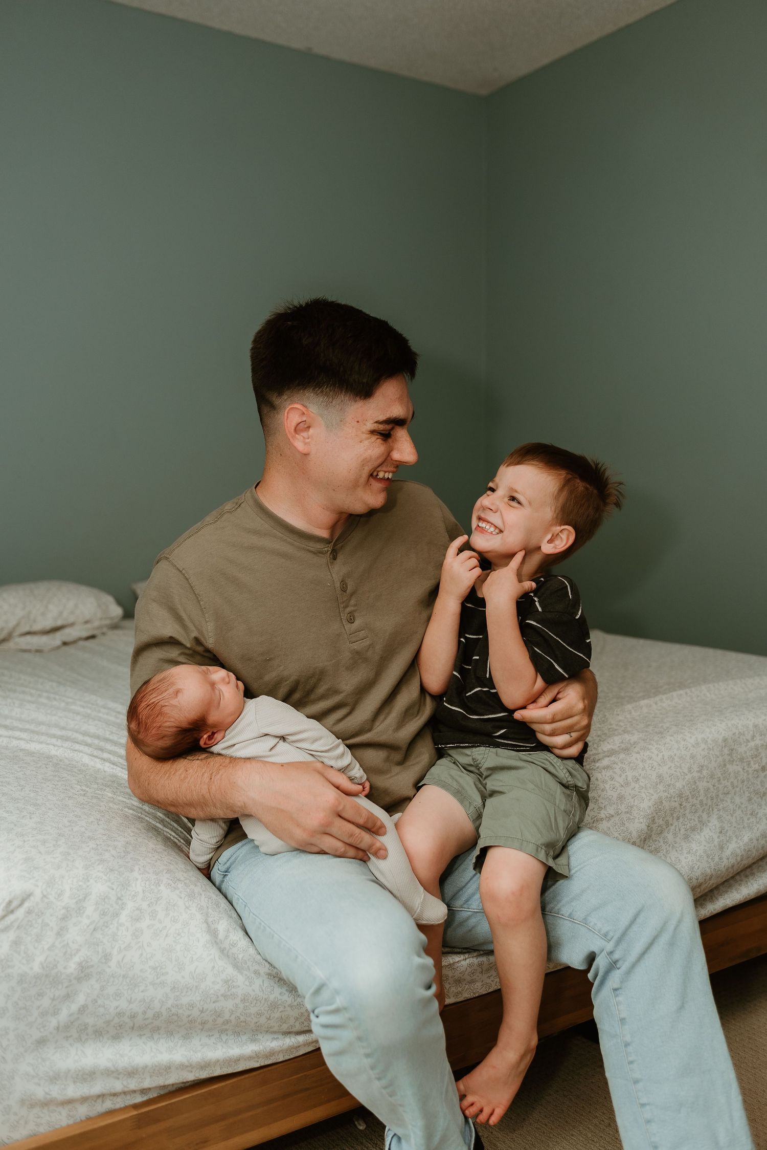 A heartwarming series of candid moments showing playful interaction on a bed with white linens against sage green walls.