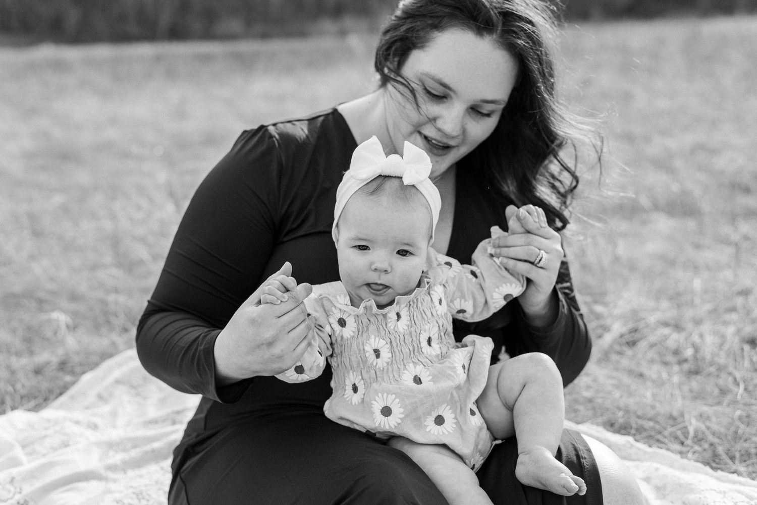 Intimate family portraits captured in black and white against natural landscape.
