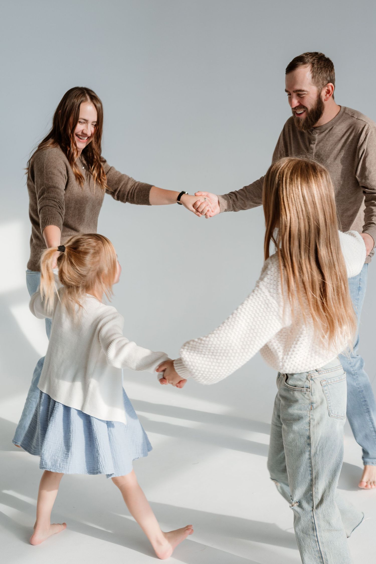 A series of candid dancing moments captured against a light background showing movement and laughter in casual attire.