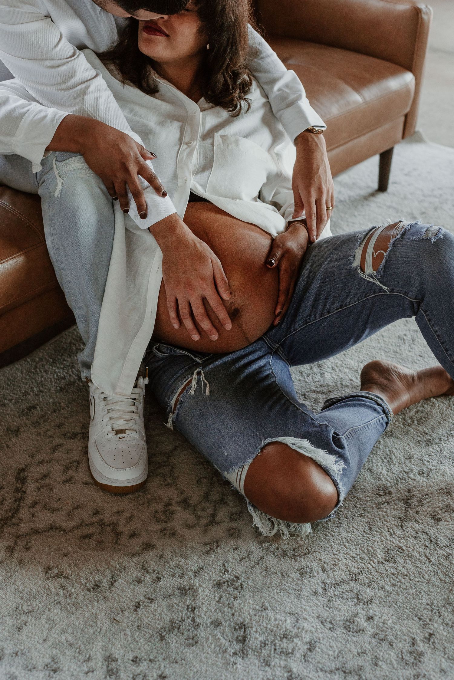 Pregnant woman cuddles husband