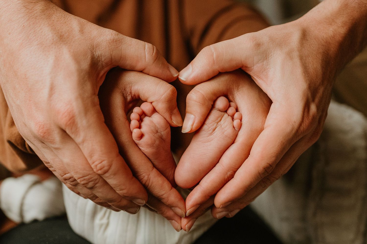 Close-up view of hands holding each other in a circle showing unity and support.