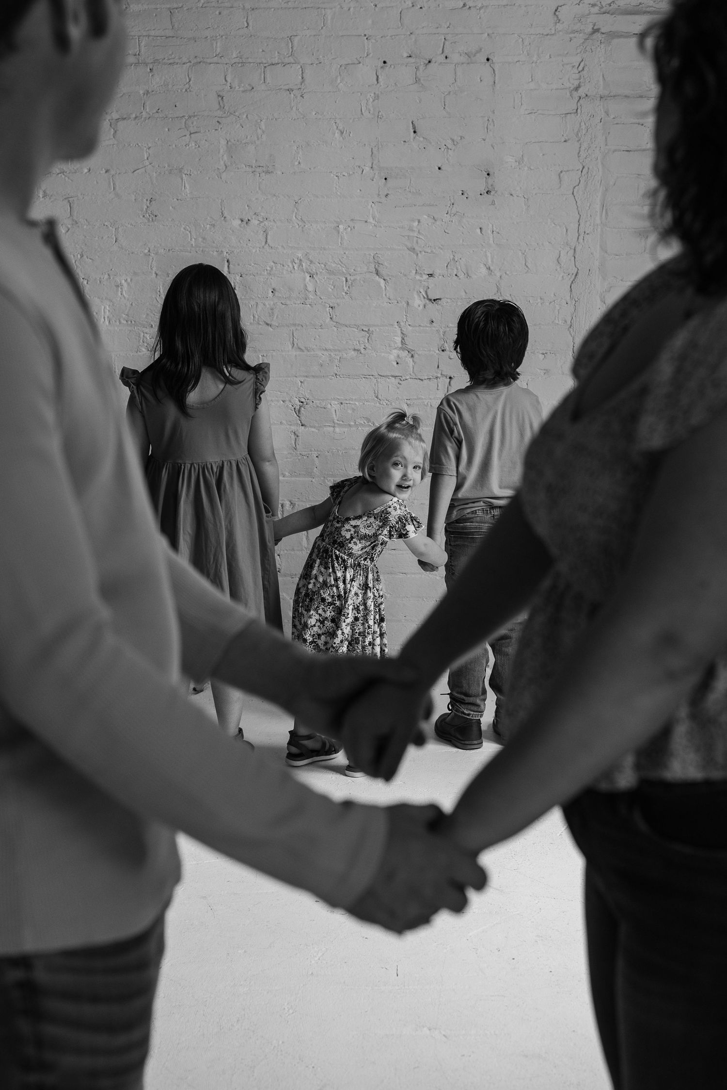 Artistic black and white silhouettes showing connected hands in a row.