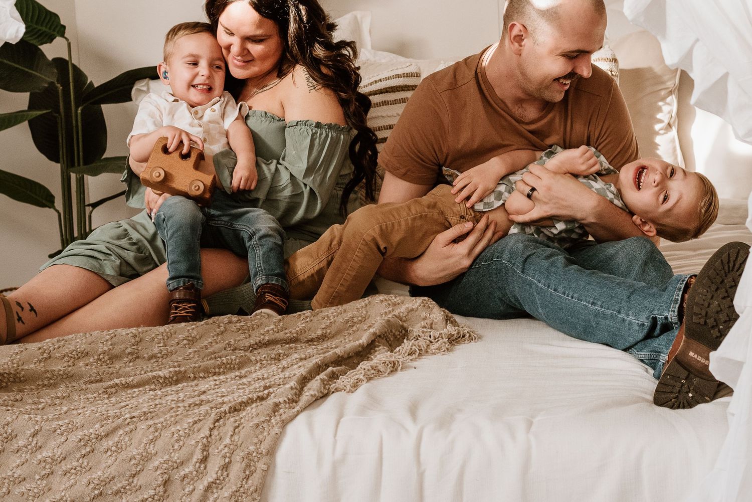 Intimate lifestyle photoshoot showing tender moments between a couple on a beige carpet.