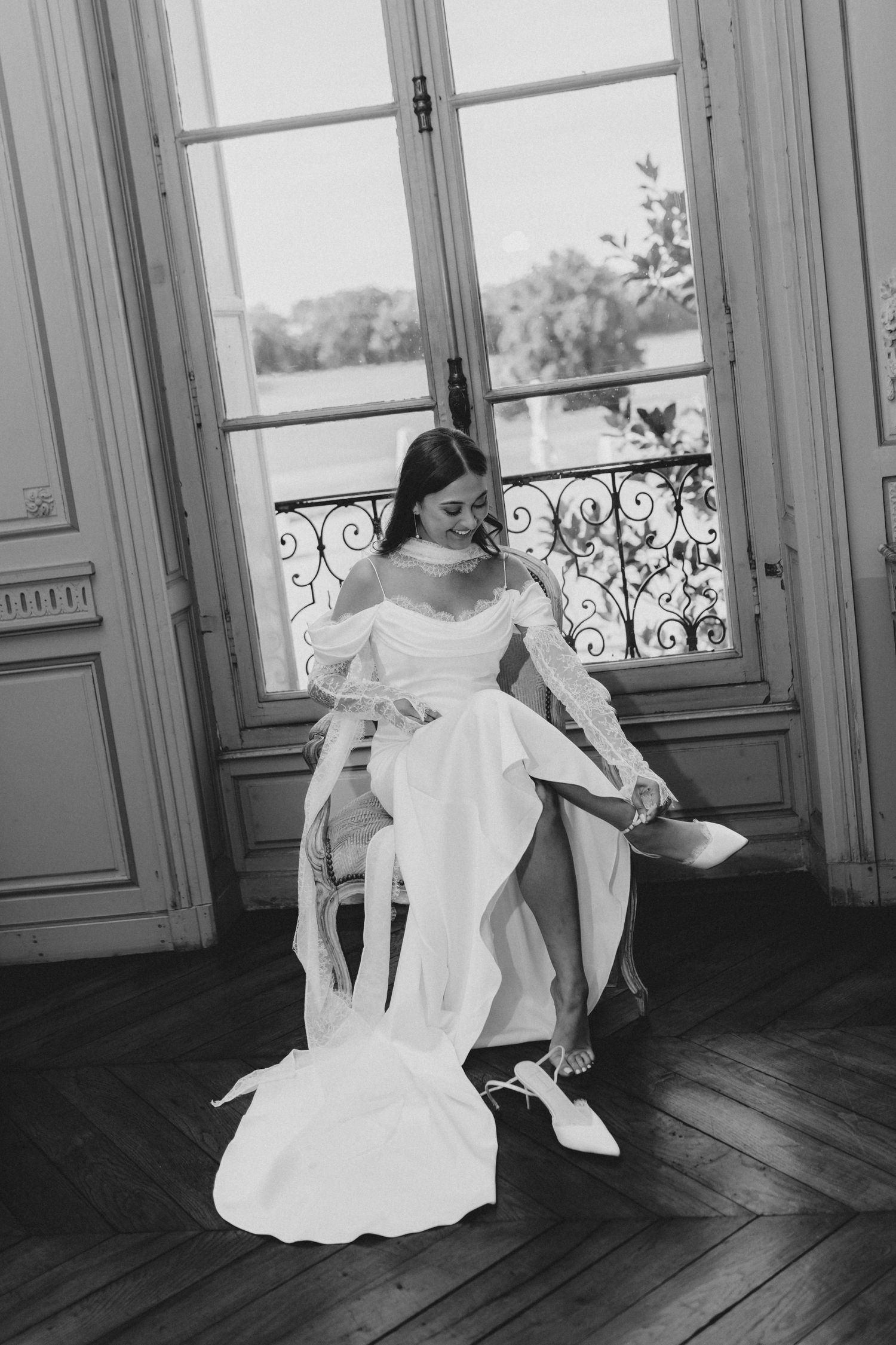 A black and white photo series showing a person in a white dress moving gracefully across a sunlit room with large windows.