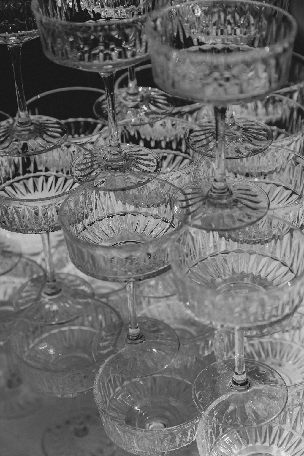 Luxury wedding details: Vintage crystal champagne coupes by Raw Studio Paris, B&W editorial photography, Art Director led storytelling