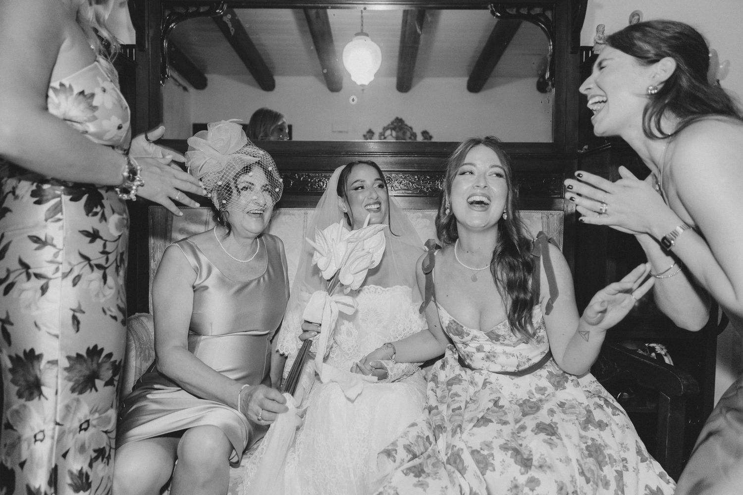Black and white photo of wedding guests celebrating at reception.