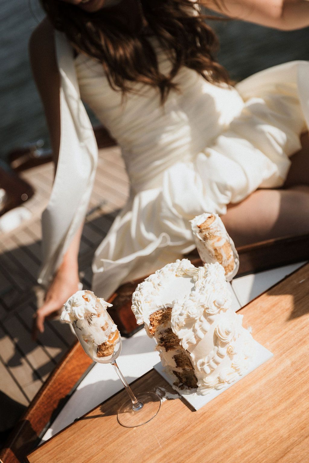 Fine art bridal prep: A white wedding dress carefully arranged on a wooden surface for a bespoke destination elopement in Paris