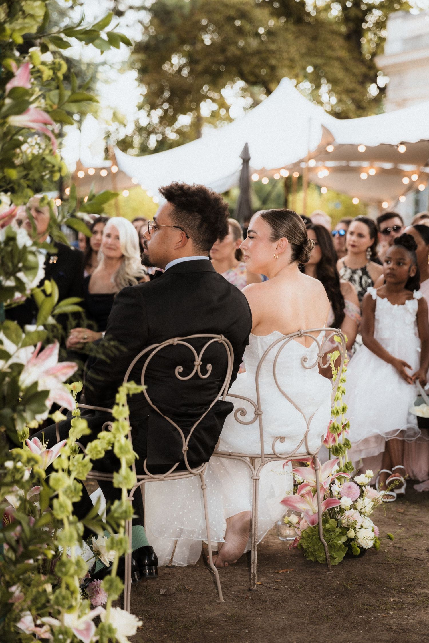 A series of wedding photos showing couples seated in elegant vintage chairs during an outdoor garden reception.