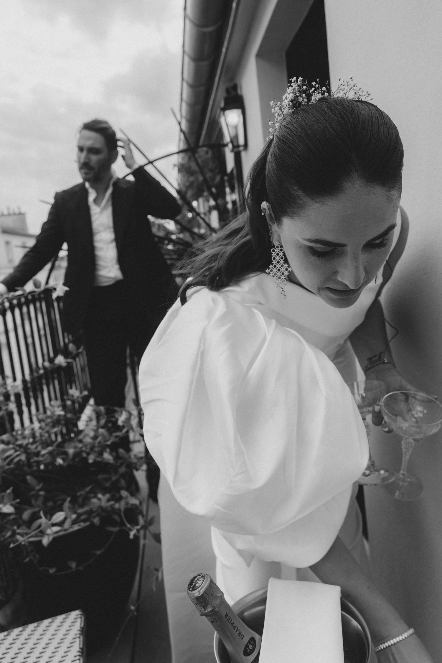 Close-up detail shots of white puff sleeve wedding attire and floral arrangements.