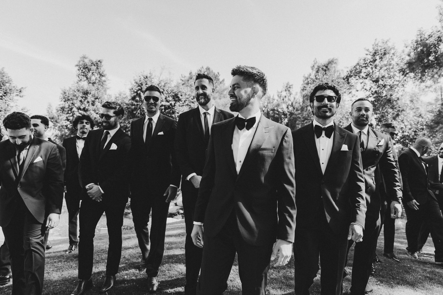 A black and white photo montage shows a group of people walking outdoors at what appears to be a formal event.