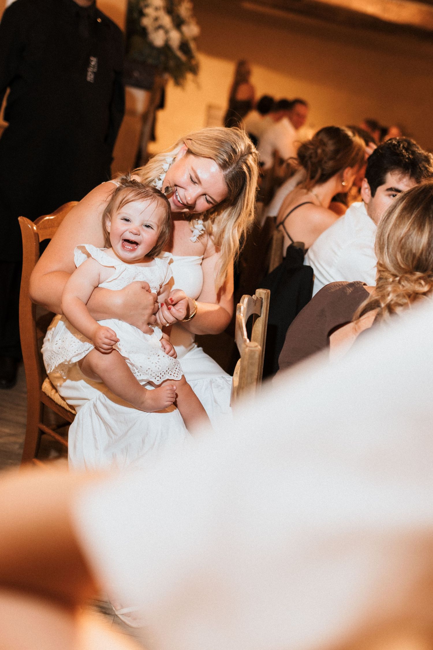 Wedding reception guests share joyful moments on the dance floor during evening celebrations.