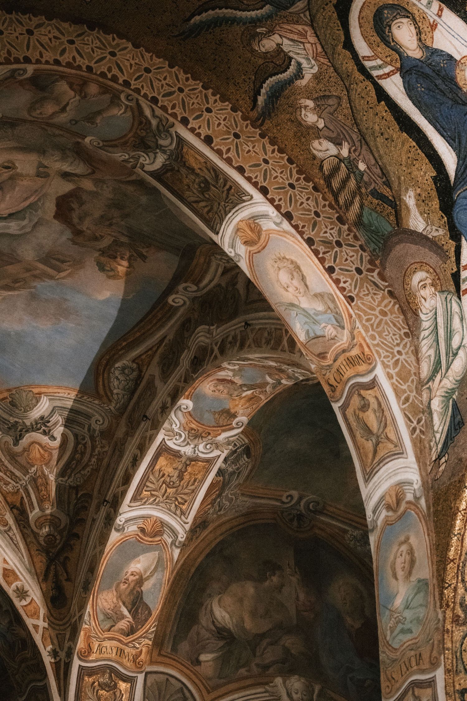 Ornate baroque ceiling with detailed religious frescoes and gilded architectural details.